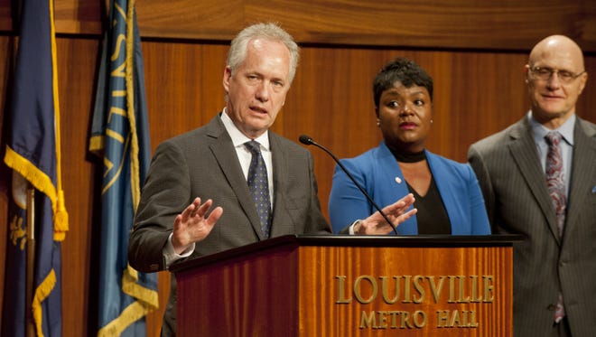 Mayor Greg Fischer announces on Sept. 19, 2017, that a $30 million indoor track and field facility will be developed in the West End and that the city has been selected as a development partner. At his right are Sadiqa Reynolds, CEO and president of the Louisville Urban League and Karl Schmitt, CEO and president of the Louisville Sports Commission.